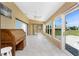 Bright sunroom with ample windows, tile flooring, and an adjacent view of the landscape at 23 Bunker Cir, Rotonda West, FL 33947