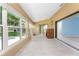 Bright sunroom with lots of natural light streaming in, tile floors, and a built-in desk at 23 Bunker Cir, Rotonda West, FL 33947