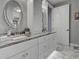 Bathroom features white cabinets, a white marble countertop, oval mirrors, and elegant light fixtures at 2590 Tarpon Cove Dr # 811, Punta Gorda, FL 33950