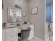 Bathroom vanity with a makeup area and framed mirror, complemented by white marble floors and countertops at 2590 Tarpon Cove Dr # 811, Punta Gorda, FL 33950