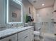 Modern bathroom with glass shower, marble-like tile, vanity with granite countertop, and illuminated mirror at 2590 Tarpon Cove Dr # 811, Punta Gorda, FL 33950