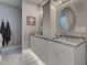 Bright bathroom featuring dual sinks, white cabinetry, granite countertops, and marble-tiled floors at 2590 Tarpon Cove Dr # 811, Punta Gorda, FL 33950