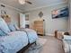 Bright bedroom with dresser, mounted TV, wood-look floors, a ceiling fan and a comfortable upholstered bed at 2590 Tarpon Cove Dr # 811, Punta Gorda, FL 33950