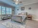 Cozy bedroom featuring a neutral color palette, a ceiling fan, and a comfortable upholstered bed at 2590 Tarpon Cove Dr # 811, Punta Gorda, FL 33950