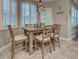 Cozy dining area with a rustic wood table, comfortable chairs, and bright natural light from the shuttered windows at 2590 Tarpon Cove Dr # 811, Punta Gorda, FL 33950