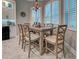 Inviting dining area features a rustic table, comfortable seating, stylish pendant lighting, and bright window views at 2590 Tarpon Cove Dr # 811, Punta Gorda, FL 33950