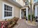 Inviting entrance with brick walkway, decorative plants, and cozy covered porch at 2590 Tarpon Cove Dr # 811, Punta Gorda, FL 33950