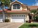 Beautful home exterior with red tile roof, well manicured lawn, and decorative shrubbery at 2590 Tarpon Cove Dr # 811, Punta Gorda, FL 33950