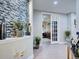 Hallway features decorative wall and leads to office through glass paned doors at 2590 Tarpon Cove Dr # 811, Punta Gorda, FL 33950
