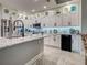 Kitchen with granite island, stainless steel appliances, white cabinets with glass display, and tile floors at 2590 Tarpon Cove Dr # 811, Punta Gorda, FL 33950