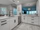 Well-appointed kitchen featuring white cabinets, granite countertops, stainless steel appliances, and modern fixtures at 2590 Tarpon Cove Dr # 811, Punta Gorda, FL 33950