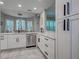 Elegant kitchen boasting white cabinets, stainless steel appliances, granite countertops, and stylish tiled flooring at 2590 Tarpon Cove Dr # 811, Punta Gorda, FL 33950