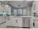 Spacious kitchen featuring white cabinets, granite countertops, a kitchen island, and stainless steel dishwasher at 2590 Tarpon Cove Dr # 811, Punta Gorda, FL 33950