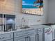Kitchenette featuring gray cabinetry, granite counters, stainless sink, and beverage fridge at 2590 Tarpon Cove Dr # 811, Punta Gorda, FL 33950