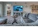 Inviting living room featuring a sectional sofa, entertainment center, and an entryway view to the bedroom at 2590 Tarpon Cove Dr # 811, Punta Gorda, FL 33950