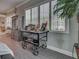 Bright living room with white plantation shutters, an industrial cart, and wood-look flooring at 2590 Tarpon Cove Dr # 811, Punta Gorda, FL 33950