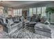 Elegant living room with a large sectional sofa, textured rug, and stylish furnishings perfect for relaxing at 2590 Tarpon Cove Dr # 811, Punta Gorda, FL 33950