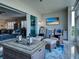 View of a modern living room adjacent to an enclosed porch area, complete with stylish furniture at 2590 Tarpon Cove Dr # 811, Punta Gorda, FL 33950