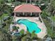Inviting community pool with lounge chairs, lush landscaping, and a serene atmosphere at 2590 Tarpon Cove Dr # 811, Punta Gorda, FL 33950