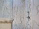 Beautiful walk-in shower features marble-like tile, mosaic tile accents, and granite shelves at 2590 Tarpon Cove Dr # 811, Punta Gorda, FL 33950