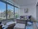 Inviting sunroom with floor-to-ceiling windows offering scenic views, comfortable seating, and stylish decor at 2590 Tarpon Cove Dr # 811, Punta Gorda, FL 33950