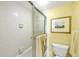 Clean bathroom featuring white tiled walls, glass shower door, and neutral-colored walls at 2700 N Beach Rd # B205, Englewood, FL 34223