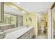 Bathroom with a large mirror, extended vanity and a separate room with a shower and toilet at 2700 N Beach Rd # B205, Englewood, FL 34223