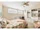 Bedroom with built-in shelves, ceiling fan, and natural light from two windows at 2700 N Beach Rd # B205, Englewood, FL 34223