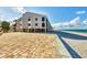 Beachside condo building showcasing ocean views and easy beach access from a paved courtyard at 2700 N Beach Rd # B205, Englewood, FL 34223
