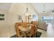 Dining room with seating for six and views of the ocean visible through the living area at 2700 N Beach Rd # B205, Englewood, FL 34223