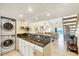 Open-concept interior with in-unit laundry, stone countertops, and views of the ocean at 2700 N Beach Rd # B205, Englewood, FL 34223