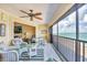Inviting sunroom with wicker furniture and a clear view of the ocean at 2700 N Beach Rd # B205, Englewood, FL 34223