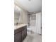 Bathroom with granite countertop vanity, bathtub, and tiled shower at 2758 Morrietta Ln, North Port, FL 34286