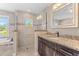Modern bathroom with a glass-enclosed shower, soaking tub, granite countertop, and natural light at 2758 Morrietta Ln, North Port, FL 34286