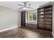 Bedroom featuring built-in bookcases, storage, and dark wood flooring at 2758 Morrietta Ln, North Port, FL 34286