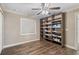 Bedroom featuring a ceiling fan, a built in bookcase, and wood floors at 2758 Morrietta Ln, North Port, FL 34286
