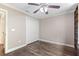 Bedroom featuring dark wood floors, neutral walls, ceiling fan and closet at 2758 Morrietta Ln, North Port, FL 34286