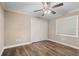 Bedroom with dark wood floors, neutral walls, ceiling fan and closet at 2758 Morrietta Ln, North Port, FL 34286