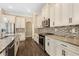 Bright kitchen with stainless steel appliances and beautiful mosaic tile backsplash at 2758 Morrietta Ln, North Port, FL 34286