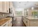 Spacious kitchen featuring granite counters, pendant lighting and dark wood flooring at 2758 Morrietta Ln, North Port, FL 34286