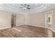 Expansive bedroom with trey ceilings, wood-look floors, and neutral walls at 2758 Morrietta Ln, North Port, FL 34286