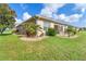 Lovely backyard with lush grass, palm trees, and an outdoor patio perfect for entertaining at 278 Crystal River Dr, Englewood, FL 34223