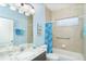 Well-lit bathroom with granite countertop, tiled shower, and coordinated blue accents at 278 Crystal River Dr, Englewood, FL 34223