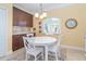 Bright breakfast nook with white table, chairs, and granite counters at 278 Crystal River Dr, Englewood, FL 34223