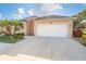 Inviting home featuring an attached two-car garage, ample driveway, and manicured landscaping at 278 Crystal River Dr, Englewood, FL 34223