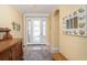 Bright and inviting foyer with decorative mirror, tile floors, and plenty of natural light at 278 Crystal River Dr, Englewood, FL 34223