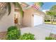 Close up of the front entrance, showing the glass adorned front door and tropical landscaping at 278 Crystal River Dr, Englewood, FL 34223