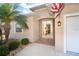 Home featuring a glass-paneled front door and tropical landscaping at 278 Crystal River Dr, Englewood, FL 34223