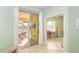 Hallway leading to lanai and a well-lit room with neutral decor and a desk at 278 Crystal River Dr, Englewood, FL 34223