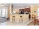 Open-concept kitchen and breakfast bar with granite countertops and bar stool seating at 278 Crystal River Dr, Englewood, FL 34223